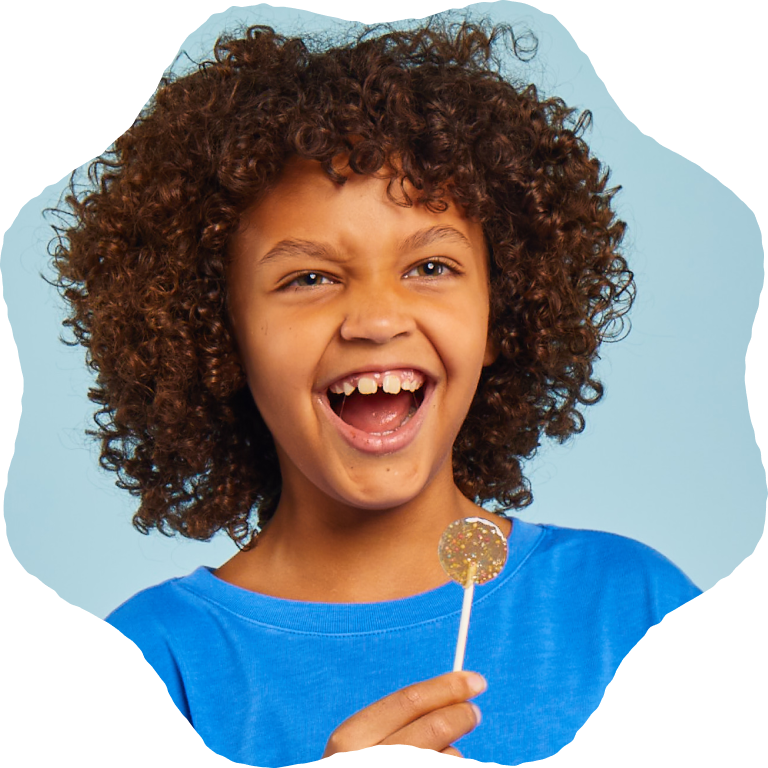 Child smiling while holding a Lolleez pop on a light blue background